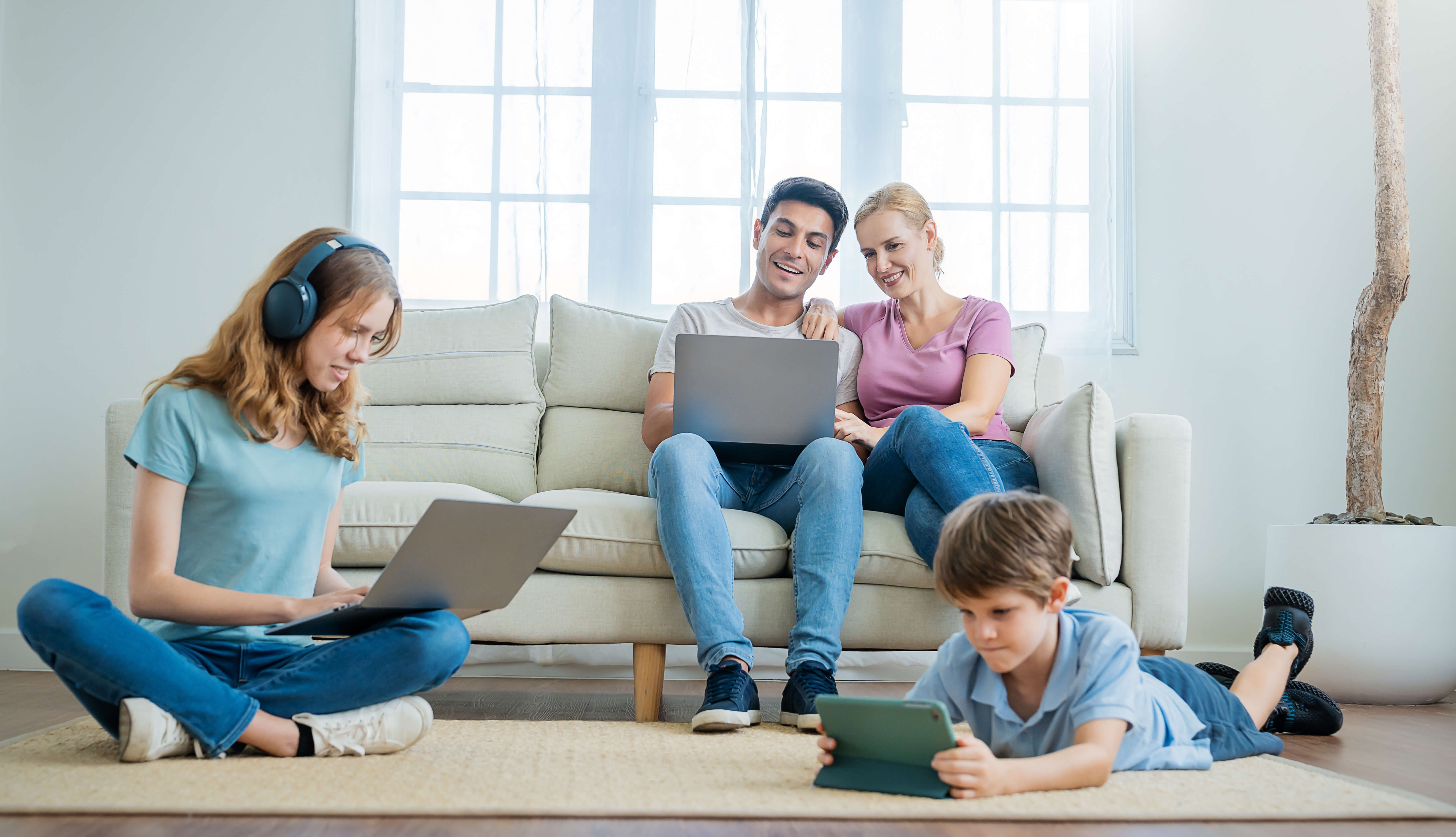 “Family using multiple internet-connected devices at the same time — showcasing the benefits of FibreMax’s NBN Accelerate Great speed upgrades for Australian homes